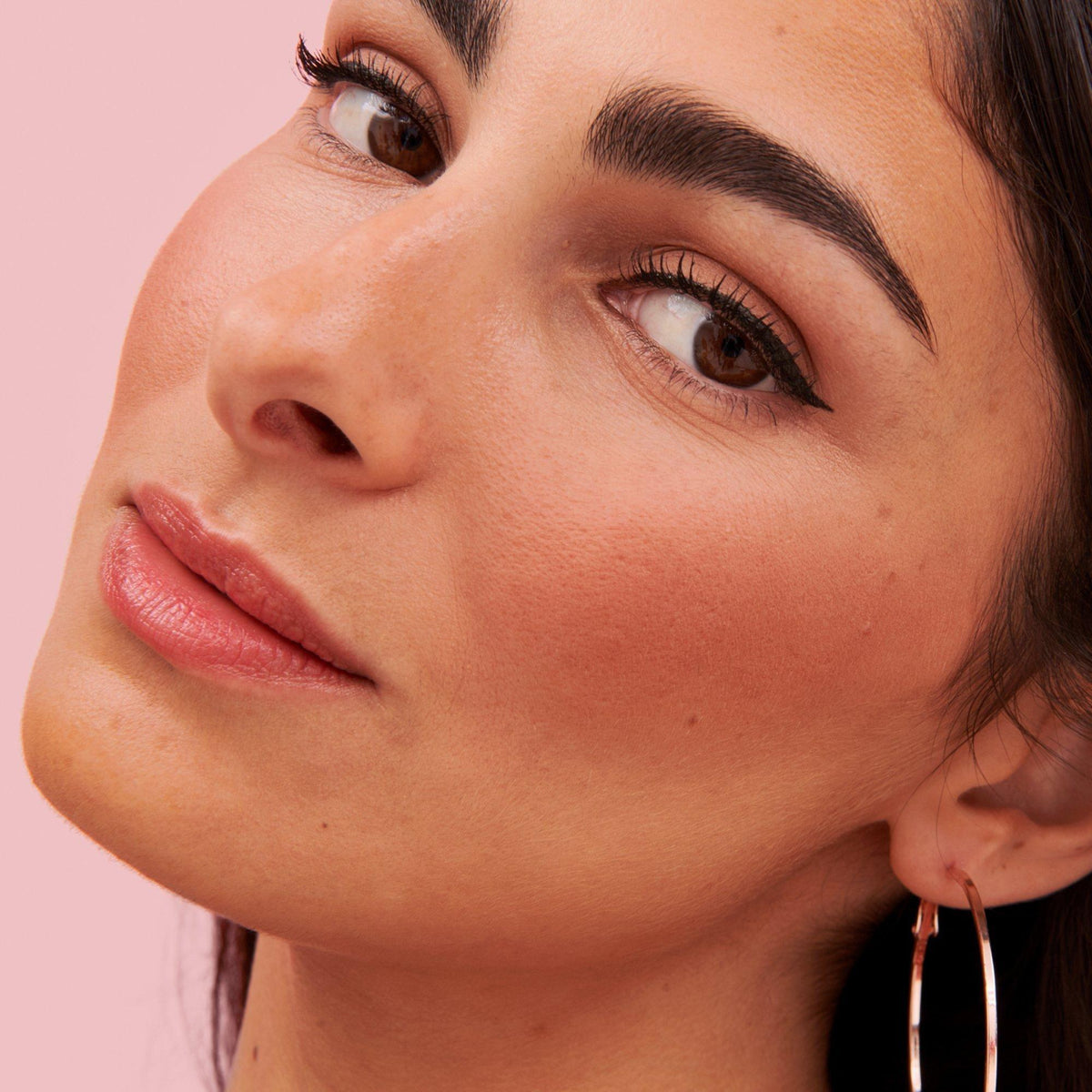 Benefit Roller Liner black matte liquid eyeliner applied as a sharp cat eye